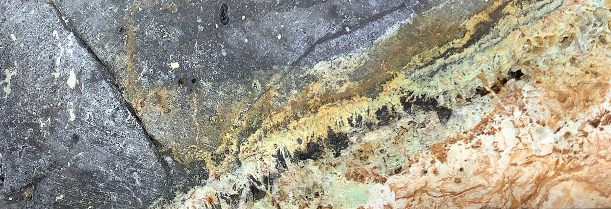 Hydrothermally altered rock with copper and gold mineralisation.